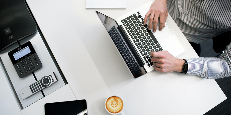 A businessman on a laptop. Preparing to sell your business? NDAs and term sheets