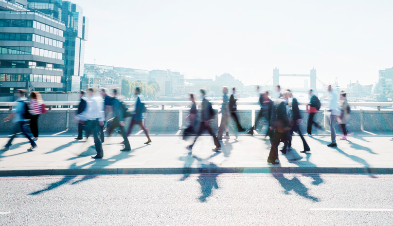 People walking across a bridge in the City. Russell-Cooke Solicitors London