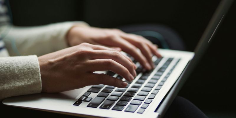 Person typing on keyboard