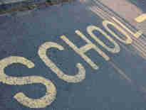 Road marking with the words 'School' in yellow. Judicial review and LGSCO complaints with local authorities