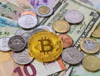 An array of fiat currencies including Euros, Dollars, Pound Sterling alongside a Bitcoin representative coin. Financial crime solicitors.