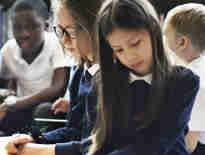 Children sat together at school. Special educational needs and disability solicitors