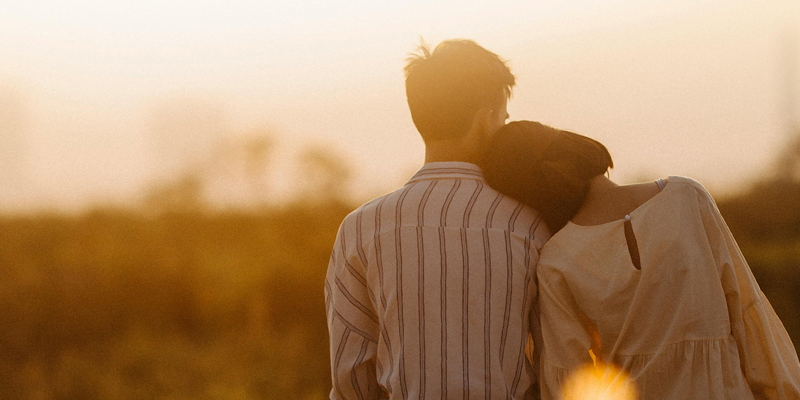 a man with a woman with her head on his shoulder with a backdrop of a field at dusk. What happens when a couple gets back together during the divorce process?